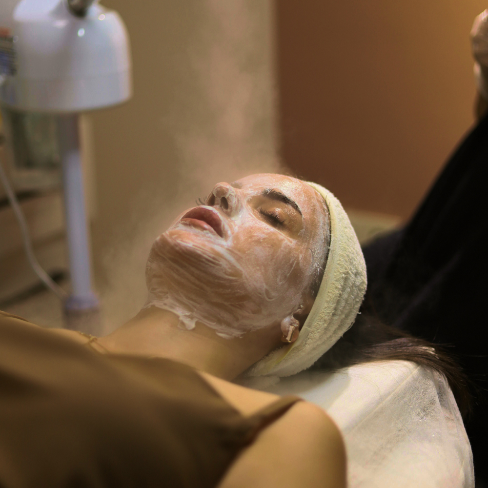 Woman relaxing during beauty treatment in salon with scent.