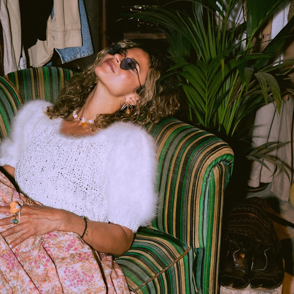 Customer relaxes in a comfortable store setting enhanced by ambient scent.