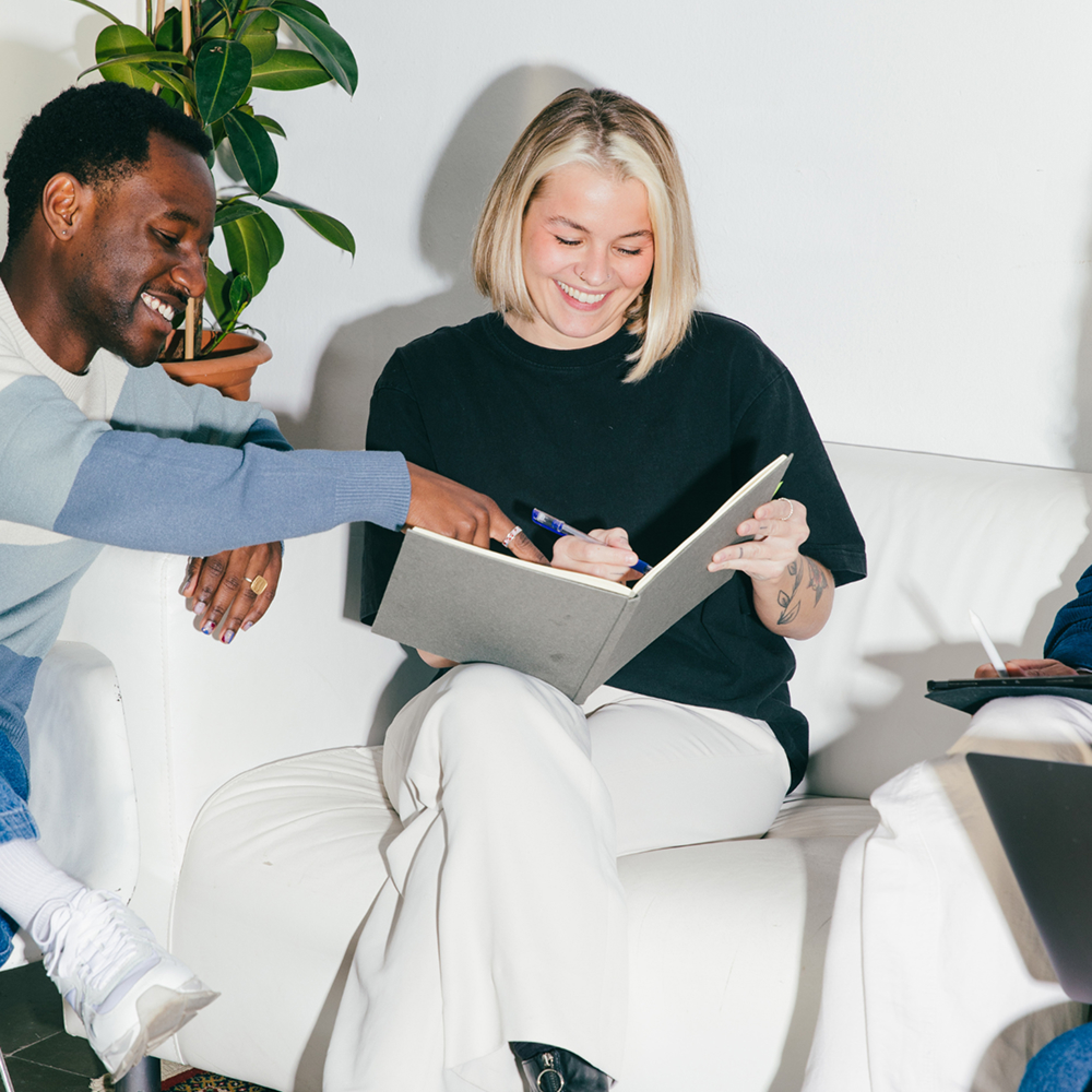 Colleagues working happily with office scent marketing in the office.